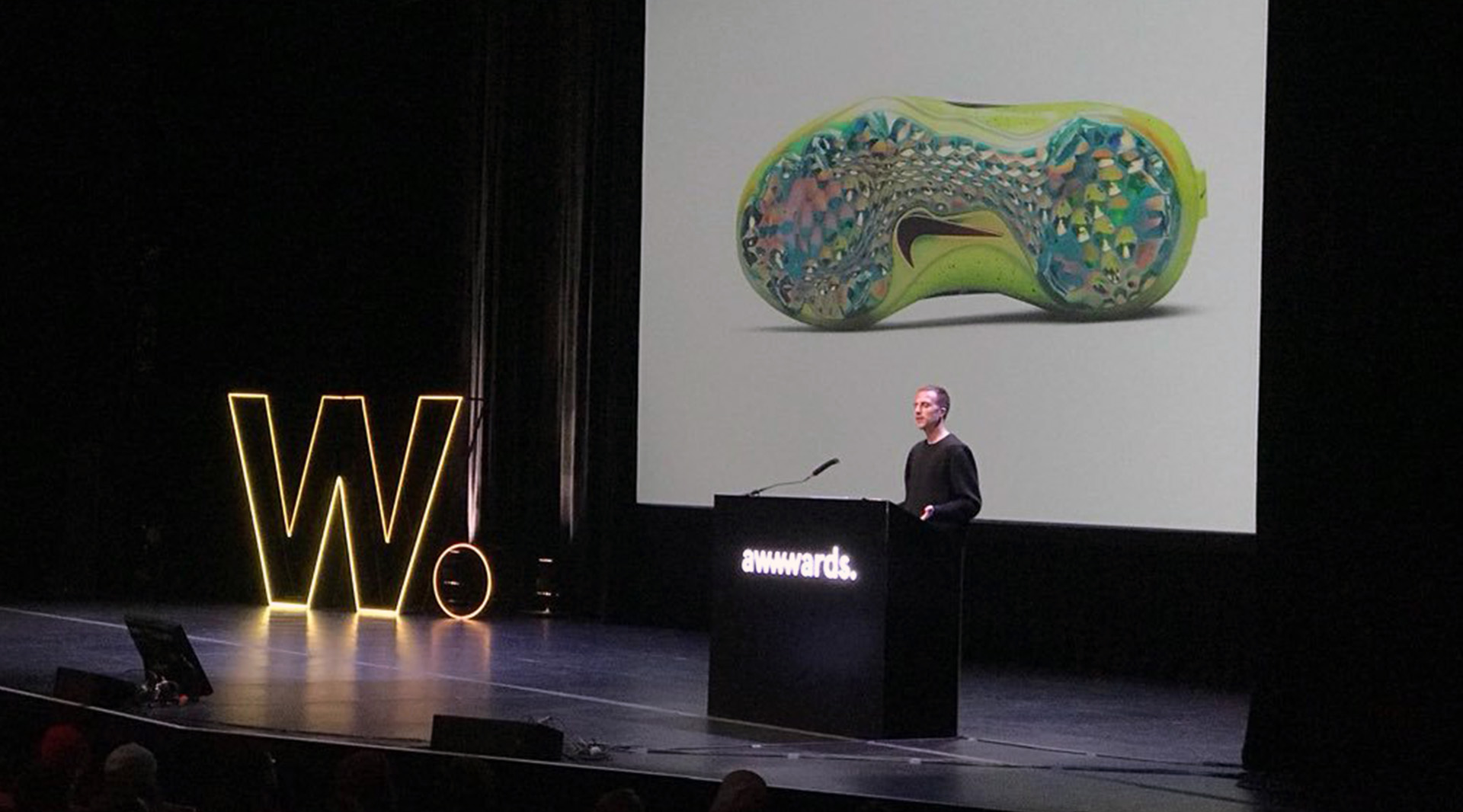 Lysandre FOLLET on stage at AWWWARDS 2018 speaking on NIKE GENERATIVE DESIGN